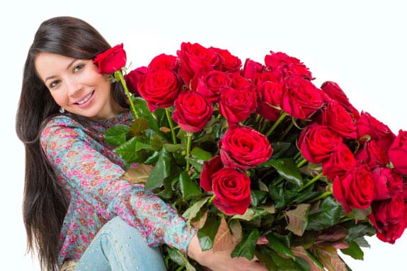 Beautiful woman with a bouquet of red roses