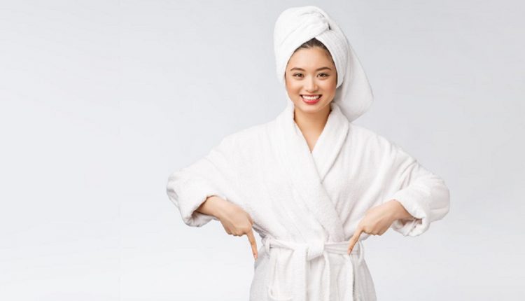 beauty-portrait-young-woman-showing-pointing-finger-empty-copy-space-asian-beauty-bathrobe