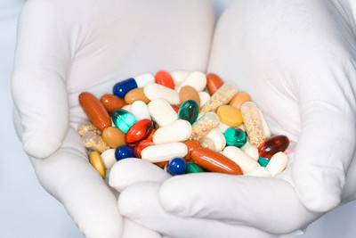 Various Medication in Hands --- Image by © moodboard/Corbis