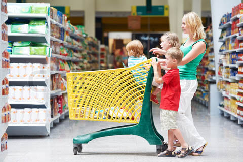 woman and children with shopping cart in supermarket store warwehouse