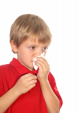 child blowing his nose
