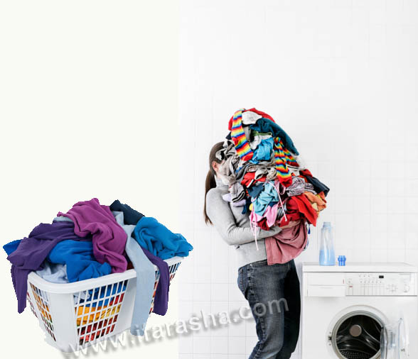 Woman carrying large pile of laundry to washing machine