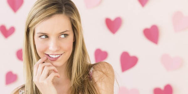 Woman Biting Lip With Heart Shaped Papers Against Colored Backgr