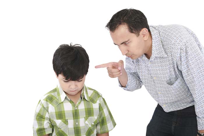 father is threatening his little boy with a finger