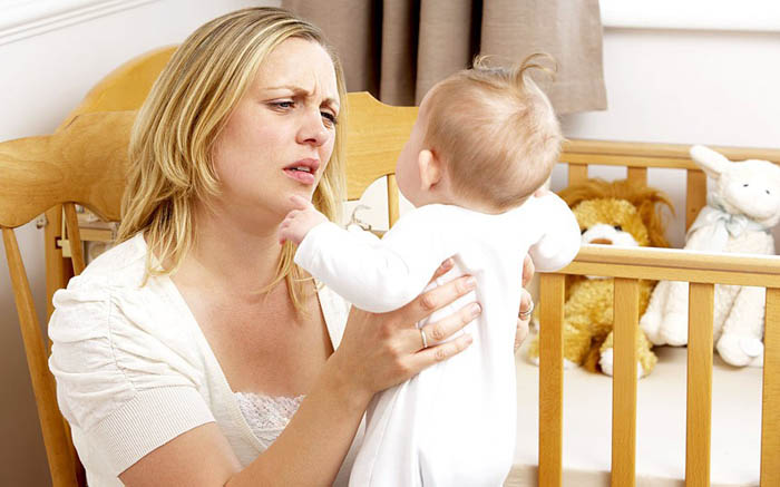 Mandatory Credit: Photo by Monkey Business Images/REX (1174626a) MODEL RELEASED Stressed Mother Holding Baby In Nursery VARIOUS