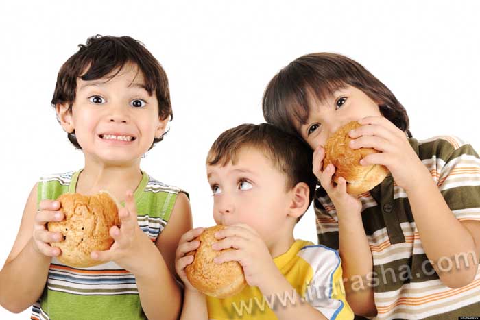Three kids eating burgers; Shutterstock ID 121198642; PO: The Huffington Post; Job: The Huffington Post; Client: The Huffington Post; Other: The Huffington Post